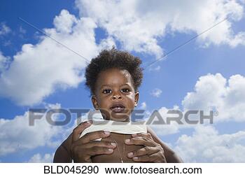 Stock Photography - french caribbean 
baby being held 
in air. fotosearch 
- search stock 
photos, pictures, 
images, and photo 
clipart