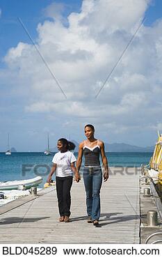 Stock Photograph - french caribbean 
mother and daughter 
holding hands. 
fotosearch - search 
stock photos, 
pictures, images, 
and photo clipart