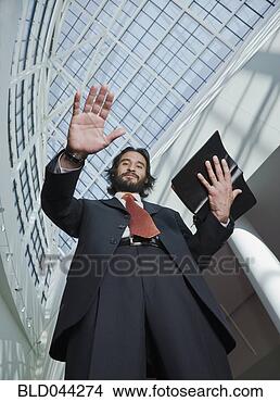 Stock Photo - hispanic businessman 
holding open book. 
fotosearch - search 
stock photos, 
pictures, images, 
and photo clipart