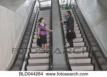 Stock Photo - hispanic businesspeople 
on escalators. 
fotosearch - search 
stock photos, 
pictures, images, 
and photo clipart
