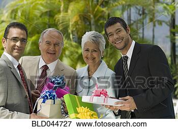 Picture - hispanic businesspeople 
holding gifts. 
fotosearch - search 
stock photos, 
pictures, images, 
and photo clipart