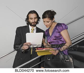 Stock Photography - hispanic businesspeople 
looking at paperwork. 
fotosearch - search 
stock photos, 
pictures, images, 
and photo clipart