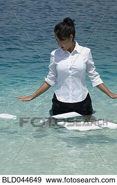 Stock Photograph - hispanic businesswoman 
with papers in 
water. fotosearch 
- search stock 
photos, pictures, 
images, and photo 
clipart