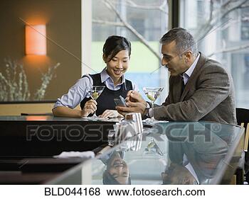 Stock Photo - man and woman 
looking at electronic 
organizer. fotosearch 
- search stock 
photos, pictures, 
images, and photo 
clipart