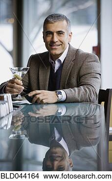 Stock Photo - middle eastern 
man holding cocktail. 
fotosearch - search 
stock photos, 
pictures, images, 
and photo clipart