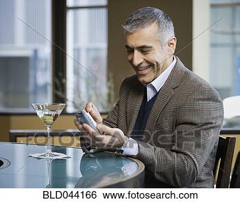 Stock Photo - middle eastern 
man using electronic 
organizer at bar. 
fotosearch - search 
stock photos, 
pictures, images, 
and photo clipart