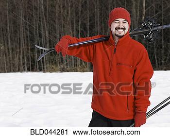Stock Photography - mixed race man 
carrying skis. 
fotosearch - search 
stock photos, 
pictures, images, 
and photo clipart