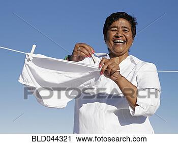 Stock Photography - mixed race woman 
hanging underwear 
on line. fotosearch 
- search stock 
photos, pictures, 
images, and photo 
clipart