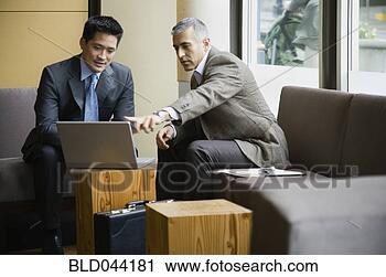Stock Photography - multi-ethnic businessmen 
looking at laptop. 
fotosearch - search 
stock photos, 
pictures, images, 
and photo clipart