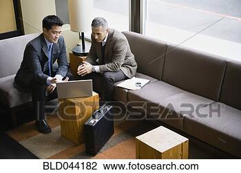 Stock Photo - multi-ethnic businessmen 
looking at laptop. 
fotosearch - search 
stock photos, 
pictures, images, 
and photo clipart