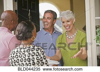 Stock Image - multi-ethnic senior 
couples greeting 
in doorway. fotosearch 
- search stock 
photos, pictures, 
images, and photo 
clipart