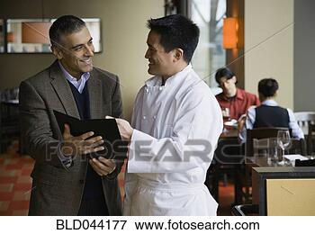 Picture - restaurant manager 
and chef discussing 
menu. fotosearch 
- search stock 
photos, pictures, 
images, and photo 
clipart