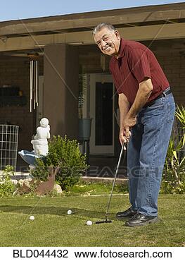 Stock Photo - senior hispanic 
man practicing 
golf. fotosearch 
- search stock 
photos, pictures, 
images, and photo 
clipart