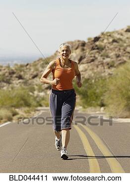 Stock Photography - senior hispanic 
woman jogging. 
fotosearch - search 
stock photos, 
pictures, images, 
and photo clipart