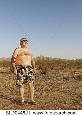 Stock Photography - senior mixed race 
man wearing bathing 
suit in desert. 
fotosearch - search 
stock photos, 
pictures, images, 
and photo clipart