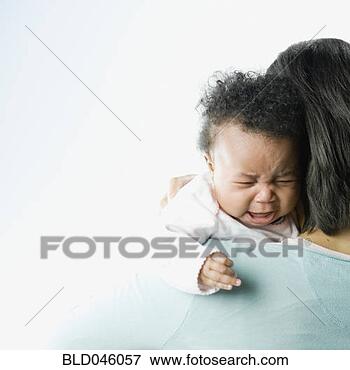 Picture - african american 
baby crying over 
mother’s shoulder. 
fotosearch - search 
stock photos, 
pictures, images, 
and photo clipart