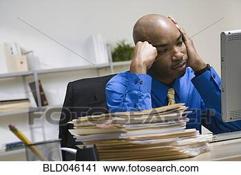 Stock Photography - african american 
businessman next 
to stack of paperwork. 
fotosearch - search 
stock photos, 
pictures, images, 
and photo clipart