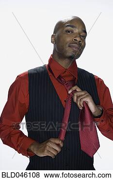 Stock Photo - african american 
man adjusting 
tie. fotosearch 
- search stock 
photos, pictures, 
images, and photo 
clipart