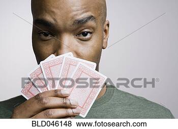 Stock Photo - african american 
man holding playing 
cards. fotosearch 
- search stock 
photos, pictures, 
images, and photo 
clipart