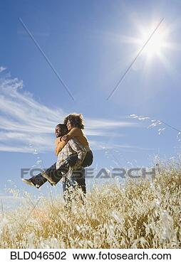 Stock Photo - african american 
man giving girlfriend 
piggy back. fotosearch 
- search stock 
photos, pictures, 
images, and photo 
clipart
