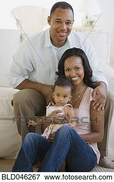 Picture - african american 
parents and baby 
in living room. 
fotosearch - search 
stock photos, 
pictures, images, 
and photo clipart