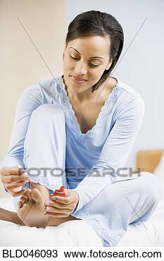Stock Photo - african american 
woman painting 
toenails. fotosearch 
- search stock 
photos, pictures, 
images, and photo 
clipart