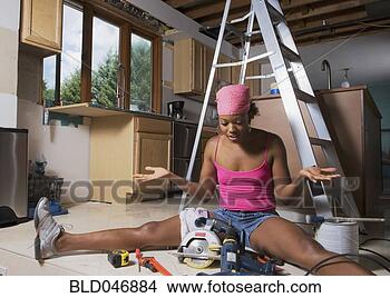 Stock Photo - african woman 
shrugging shoulders 
at power tools. 
fotosearch - search 
stock photos, 
pictures, images, 
and photo clipart
