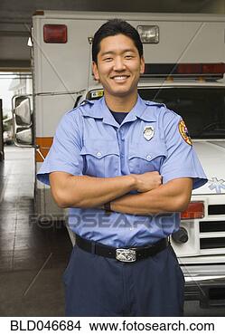 Stock Photo - asian male paramedic 
in front of ambulance. 
fotosearch - search 
stock photos, 
pictures, images, 
and photo clipart