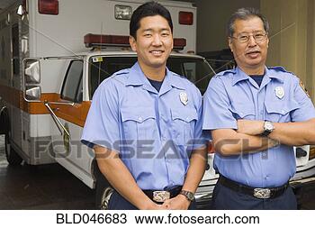 Stock Photo - asian male paramedics 
in front of ambulance. 
fotosearch - search 
stock photos, 
pictures, images, 
and photo clipart