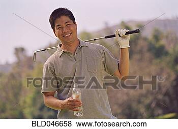 Stock Photo - asian man holding 
golf club. fotosearch 
- search stock 
photos, pictures, 
images, and photo 
clipart
