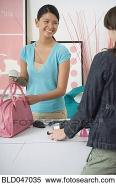 Stock Image - asian store clerk 
ringing up purchase. 
fotosearch - search 
stock photos, 
pictures, images, 
and photo clipart