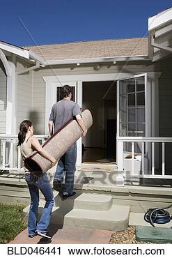 Stock Photography - ethnic-ethnic 
couple carrying 
rug. fotosearch 
- search stock 
photos, pictures, 
images, and photo 
clipart