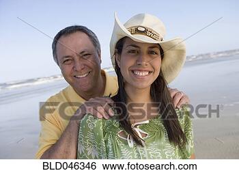 Stock Photo - hispanic father 
with hands on 
daughter’s shoulders. 
fotosearch - search 
stock photos, 
pictures, images, 
and photo clipart
