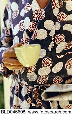 Stock Image - hispanic man holding 
coffee mug. fotosearch 
- search stock 
photos, pictures, 
images, and photo 
clipart
