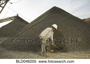 Stock Image - hispanic man shoveling 
gravel. fotosearch 
- search stock 
photos, pictures, 
images, and photo 
clipart
