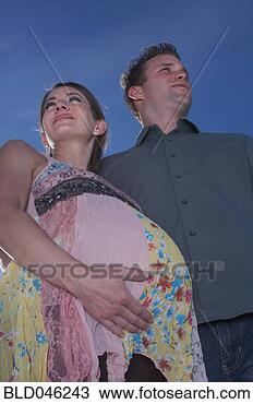 Stock Photo - low angle view 
of pregnant couple. 
fotosearch - search 
stock photos, 
pictures, images, 
and photo clipart