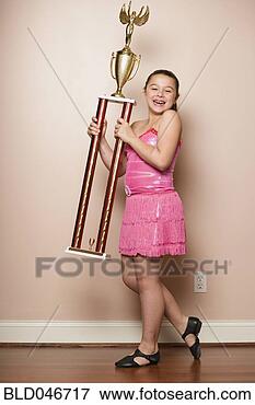 Picture - mixed race girl 
holding dancing 
trophy. fotosearch 
- search stock 
photos, pictures, 
images, and photo 
clipart