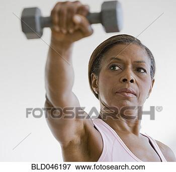 Picture - senior african 
american woman 
lifting weights. 
fotosearch - search 
stock photos, 
pictures, images, 
and photo clipart