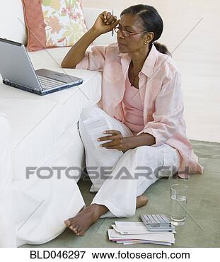 Picture - senior african 
american woman 
paying bills. 
fotosearch - search 
stock photos, 
pictures, images, 
and photo clipart