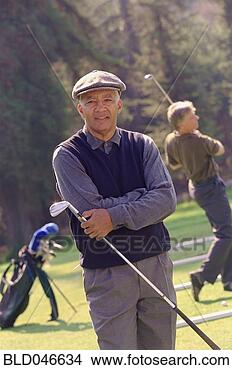 Stock Photo - senior african 
american man holding 
golf club. fotosearch 
- search stock 
photos, pictures, 
images, and photo 
clipart