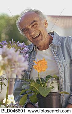 Stock Photography - senior hispanic 
man holding potted 
plant. fotosearch 
- search stock 
photos, pictures, 
images, and photo 
clipart