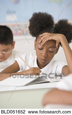 Stock Photo - african american 
girl writing at 
school desk. fotosearch 
- search stock 
photos, pictures, 
images, and photo 
clipart