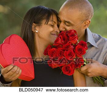 Picture - african american 
man giving valentine’s 
day gifts to wife. 
fotosearch - search 
stock photos, 
pictures, images, 
and photo clipart