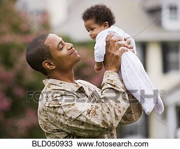 Stock Photo - african american 
military father 
holding baby. 
fotosearch - search 
stock photos, 
pictures, images, 
and photo clipart