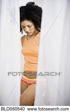 Stock Photography - african american 
woman through 
parted curtains. 
fotosearch - search 
stock photos, 
pictures, images, 
and photo clipart