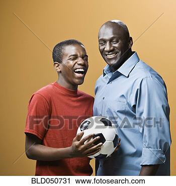 Stock Photography - african father 
and son holding 
soccer ball. fotosearch 
- search stock 
photos, pictures, 
images, and photo 
clipart
