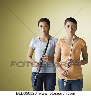 Stock Photo - asian girls holding 
wind instruments. 
fotosearch - search 
stock photos, 
pictures, images, 
and photo clipart