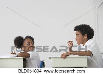 Stock Photo - hispanic boy blowing 
spitball on girl 
in class. fotosearch 
- search stock 
photos, pictures, 
images, and photo 
clipart