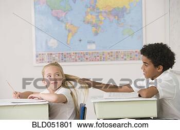 Stock Photography - hispanic boy pulling 
on girl’s hair 
in class. fotosearch 
- search stock 
photos, pictures, 
images, and photo 
clipart