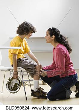 Stock Photo - hispanic boy showing 
skinned knee to 
mother. fotosearch 
- search stock 
photos, pictures, 
images, and photo 
clipart
